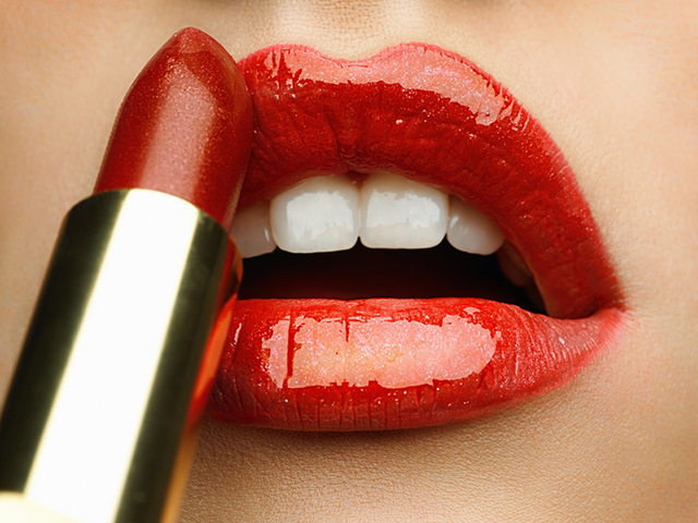 Beauty photo (close-up) of red female lips with applying lipstic